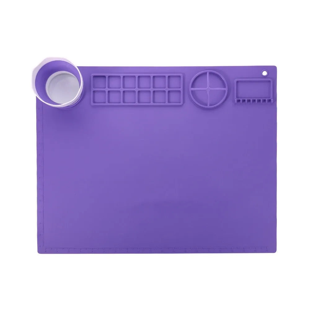 Light blue silicone painting mat with two round bowls on a 50cm by 40cm rectangular surface.