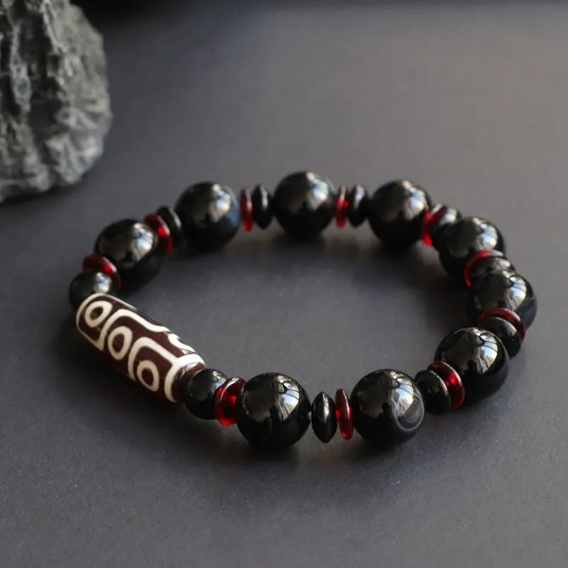 Hand-woven black agate dzi bead bracelet with geometry pattern on wrist