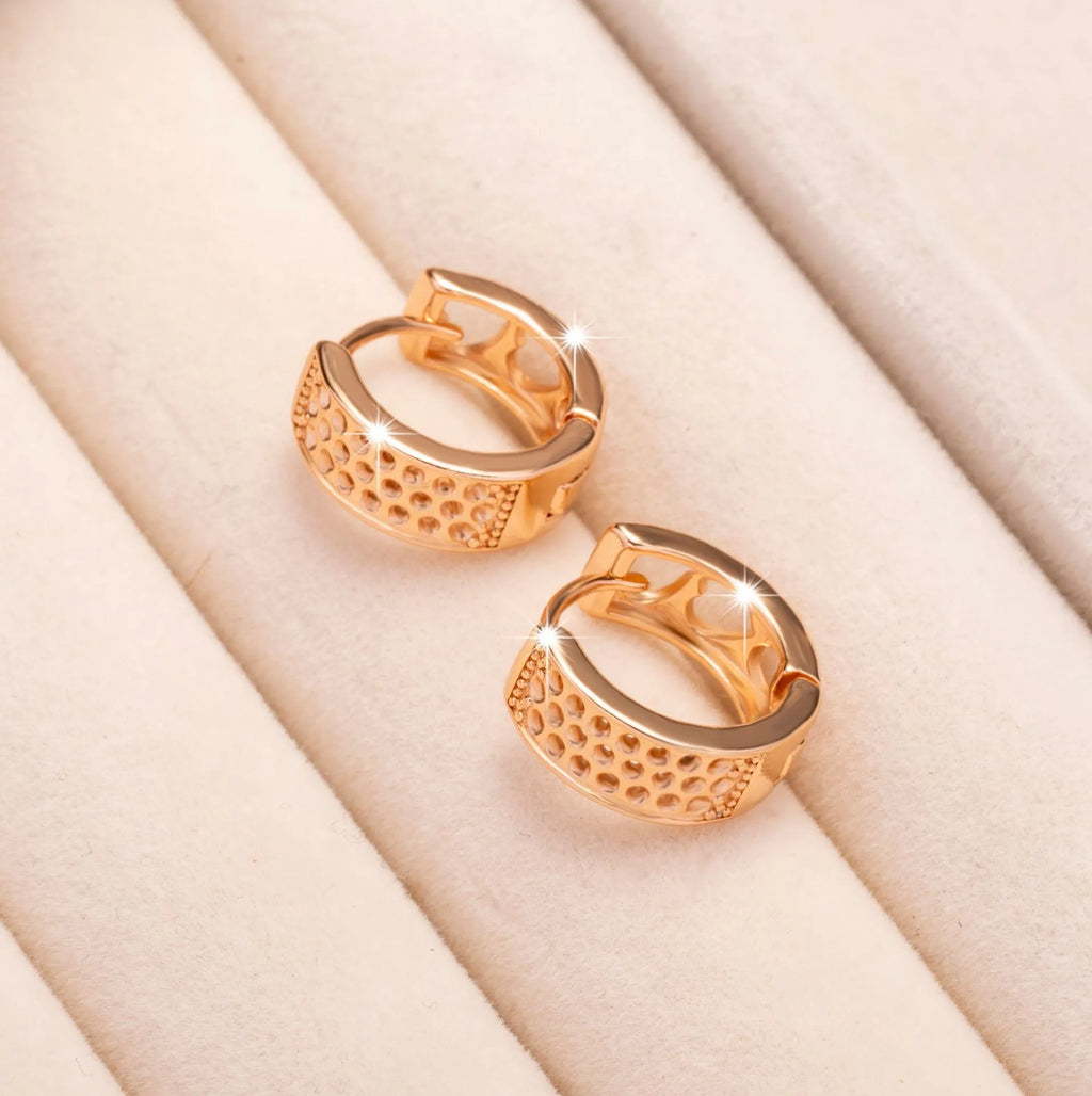 Rose gold women's earrings with three hollowed-out hearts in circular drop design