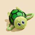 Turtle shaped dog chewing toy with rope knot legs and natural rubber shell in grey, green or orange