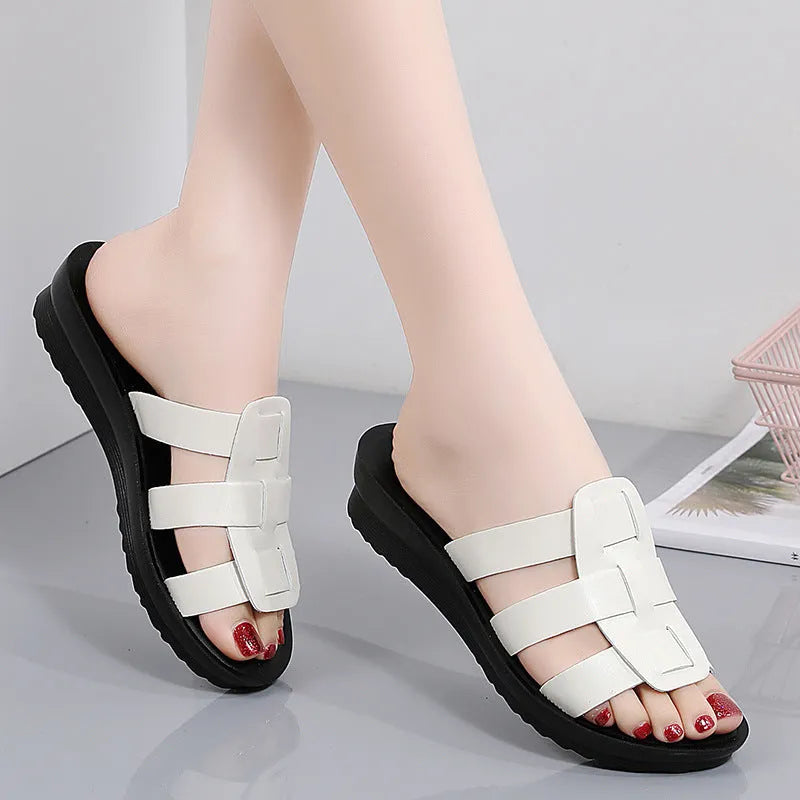 Beige women's flat-bottom slippers with a PU leather toe and soft sole.
