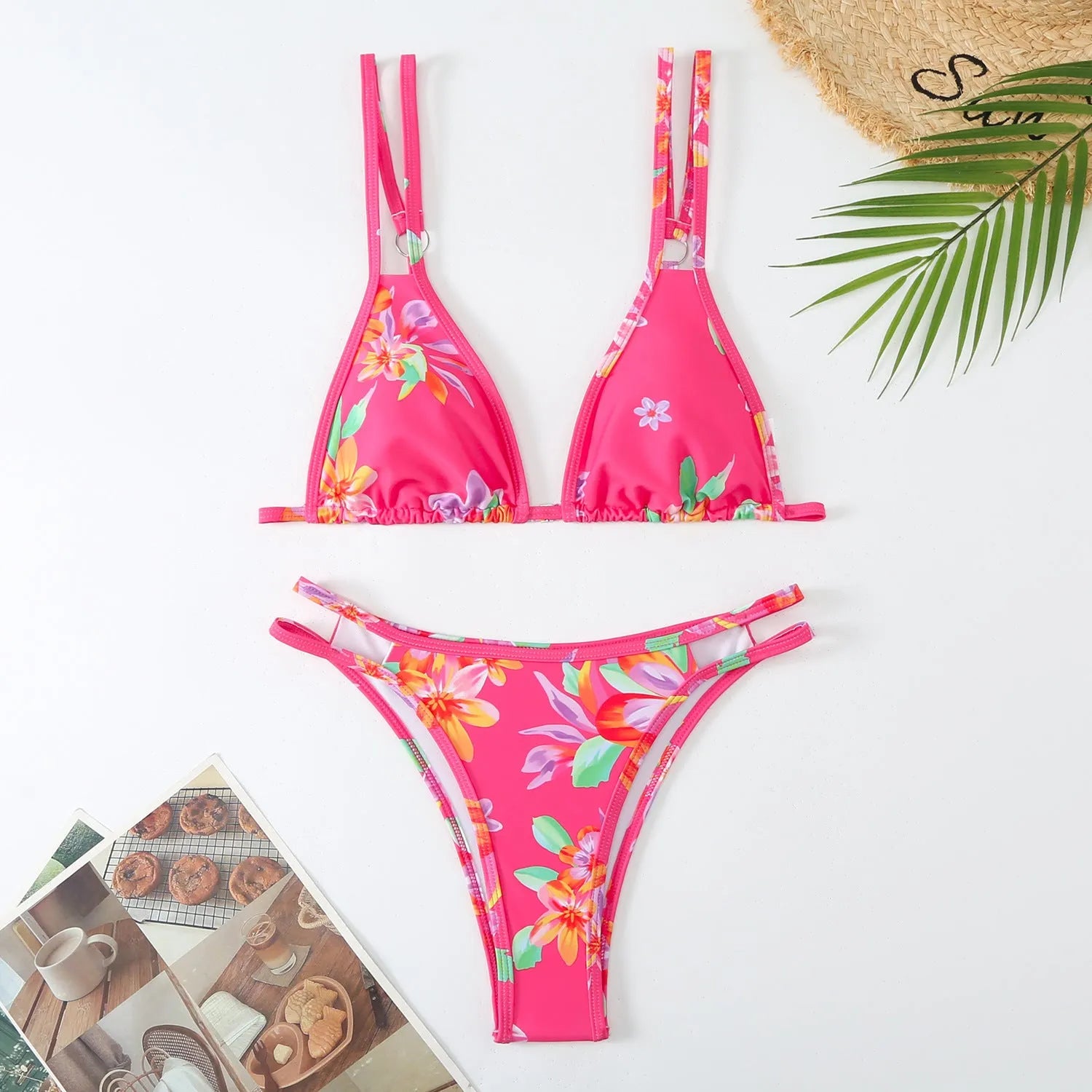 Women's blue halter-style swim briefs with a floral pattern, backless design.