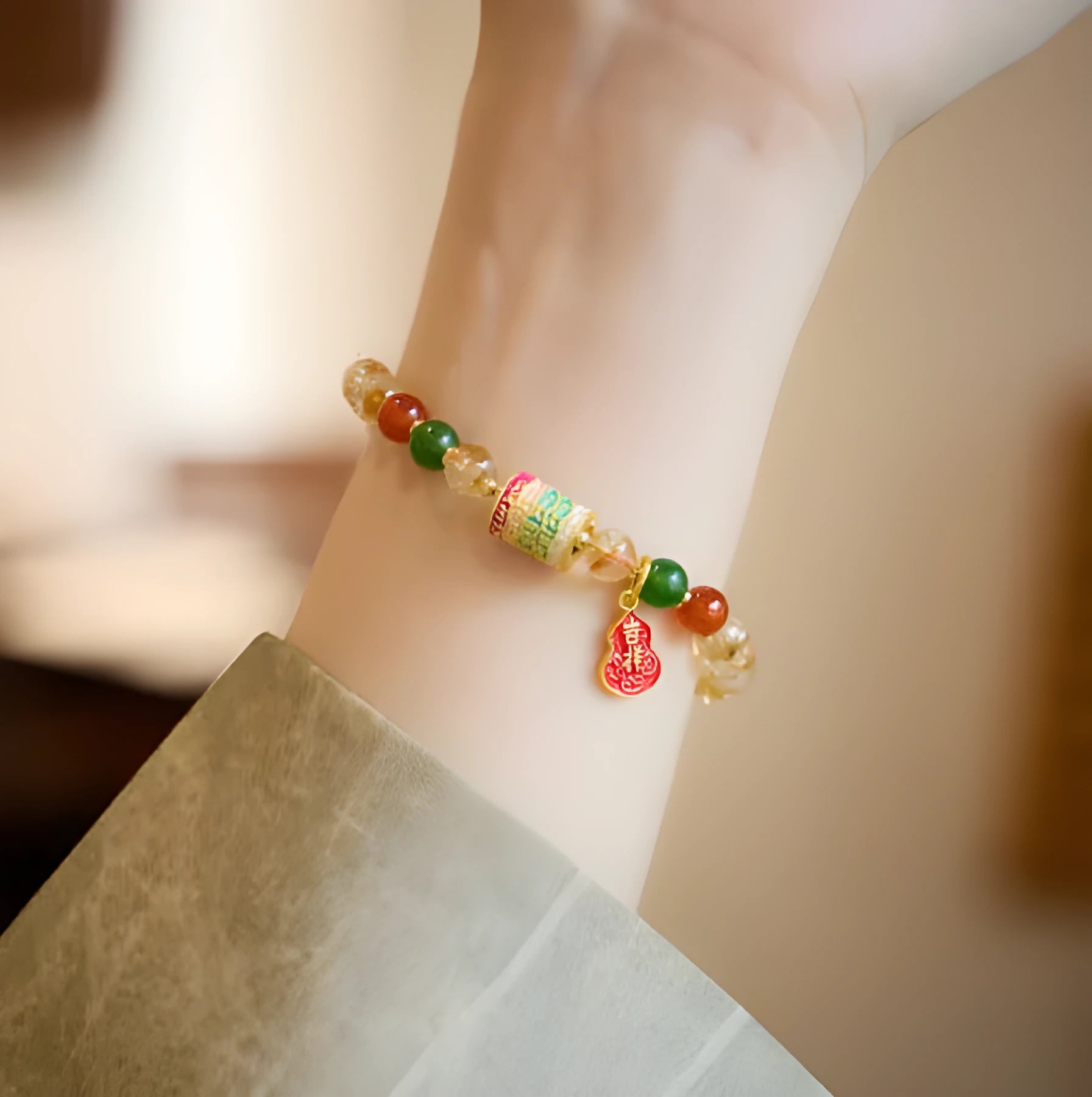 Hand-woven citrine five sutra bracelet with 6mm geometric beads on a wrist.