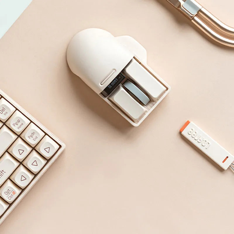 Xiaoqiao tofu colour wireless mouse with seven buttons and a scroll wheel on a desk.