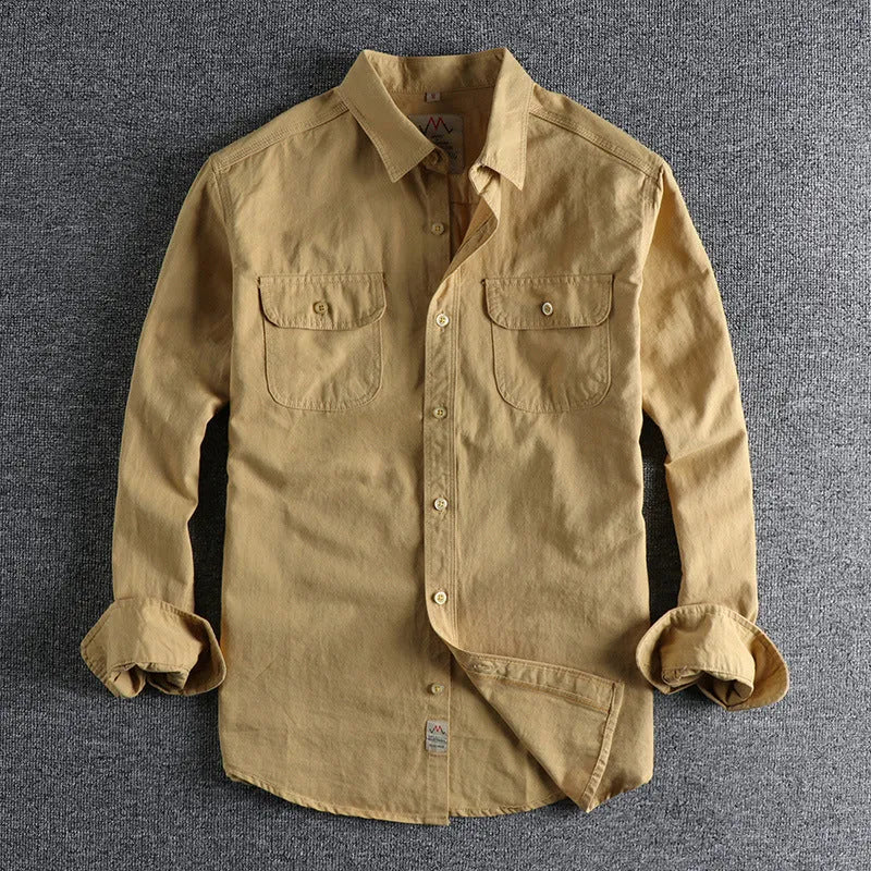 Men's solid colour cotton long sleeve shirt in a cardigan style on a hanger.