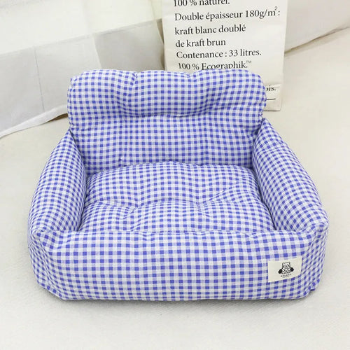 Grey and blue plaid cloth dog travel nest for use in a car, shown in two size options.