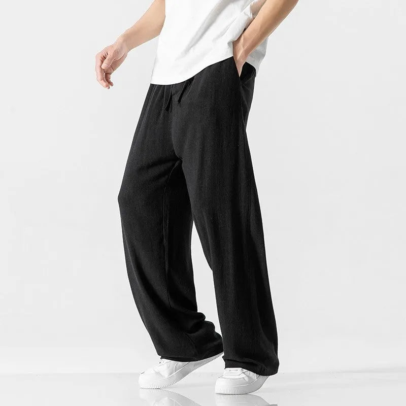 Men's beige linen casual trousers with a loose straight-leg fit and drawstring waist.