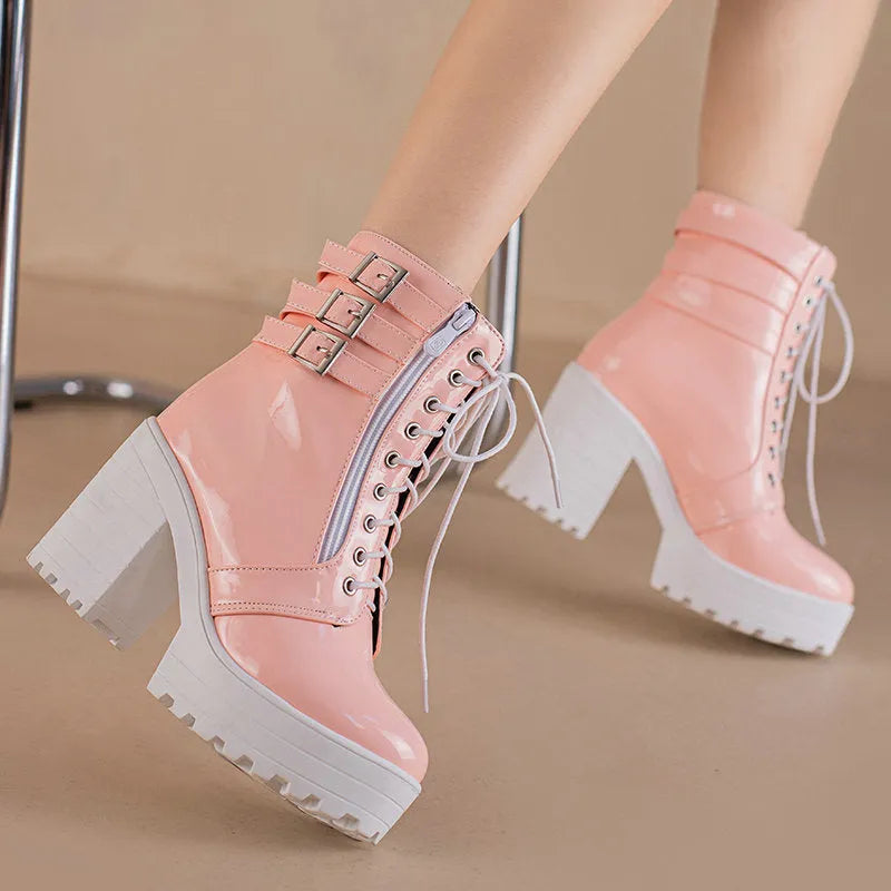 Women's black thick-heeled lace-up ankle boots with a round toe and rubber sole on a waterproof platform.