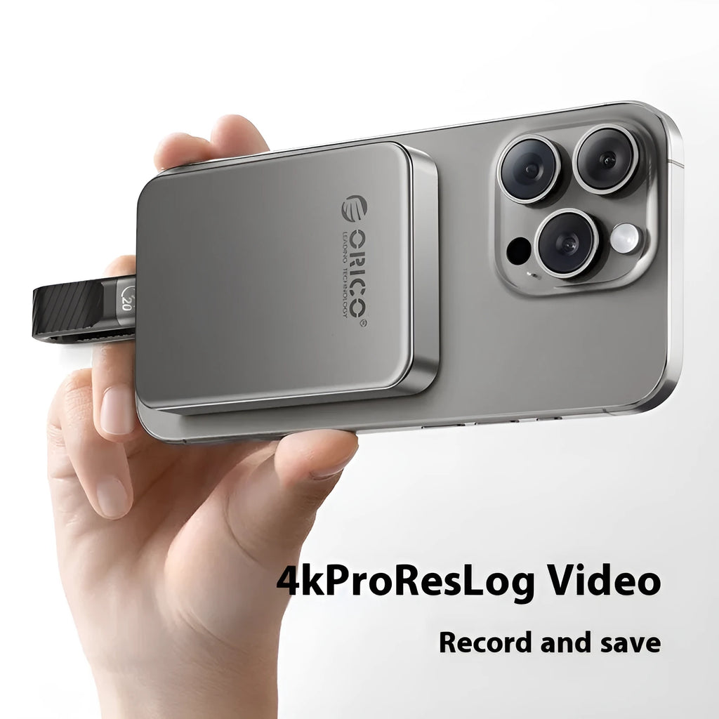 Grey magnetic mobile solid state drive with ultra-thin design next to C to C cable and magnetic suction ring