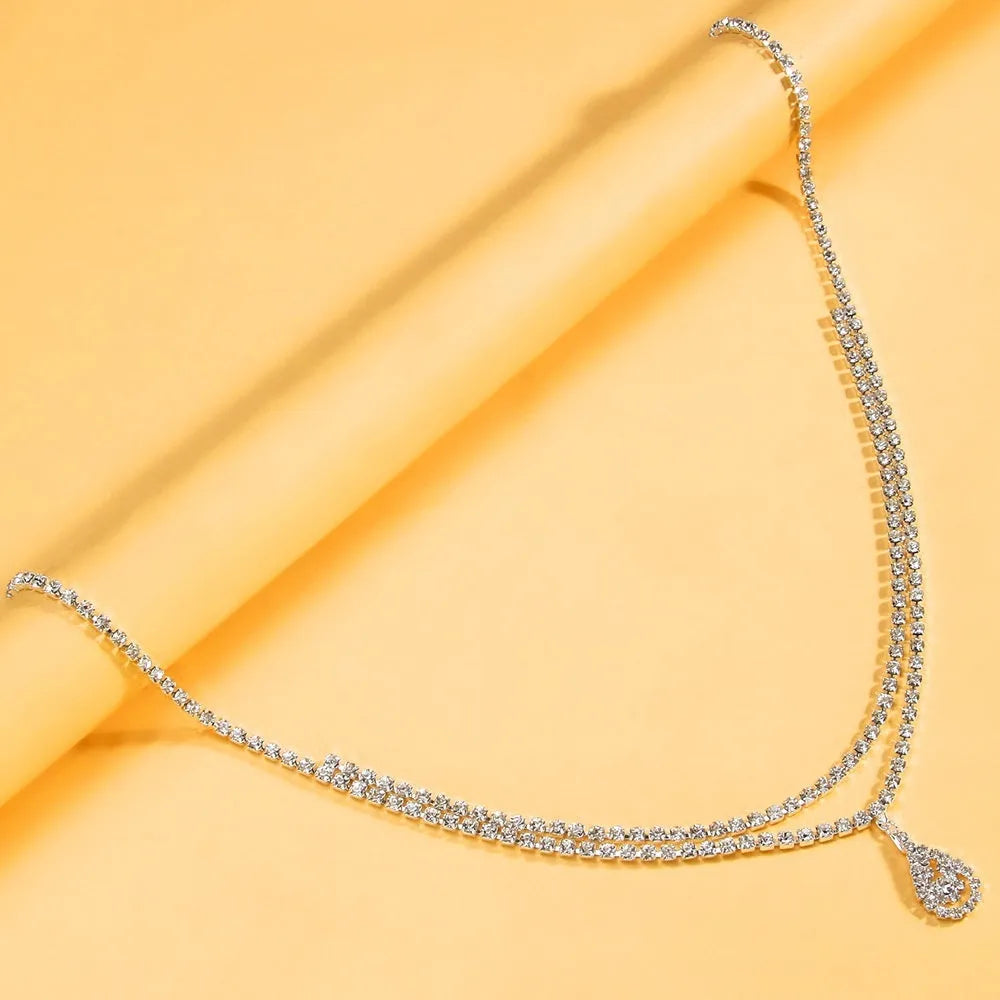 Gold rhinestone waist chain with tassel drop pendant and lobster clasp closure