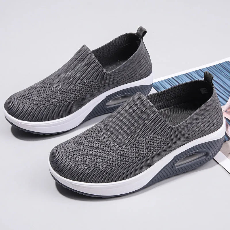 Women's casual running shoes with mesh and PU upper in light gray, showing round toe and mid heel.