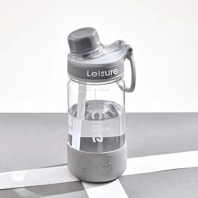 A grey heat-resistant plastic portable cup with a cylindrical shape on a plain background.