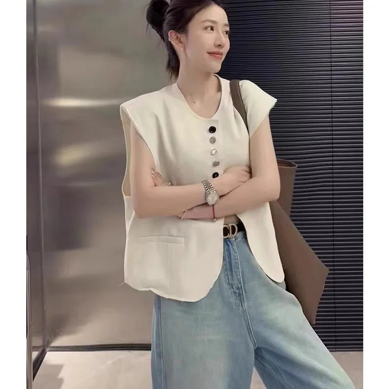 Women's loose fit polyester vest in milky white and black colours with pocket details.