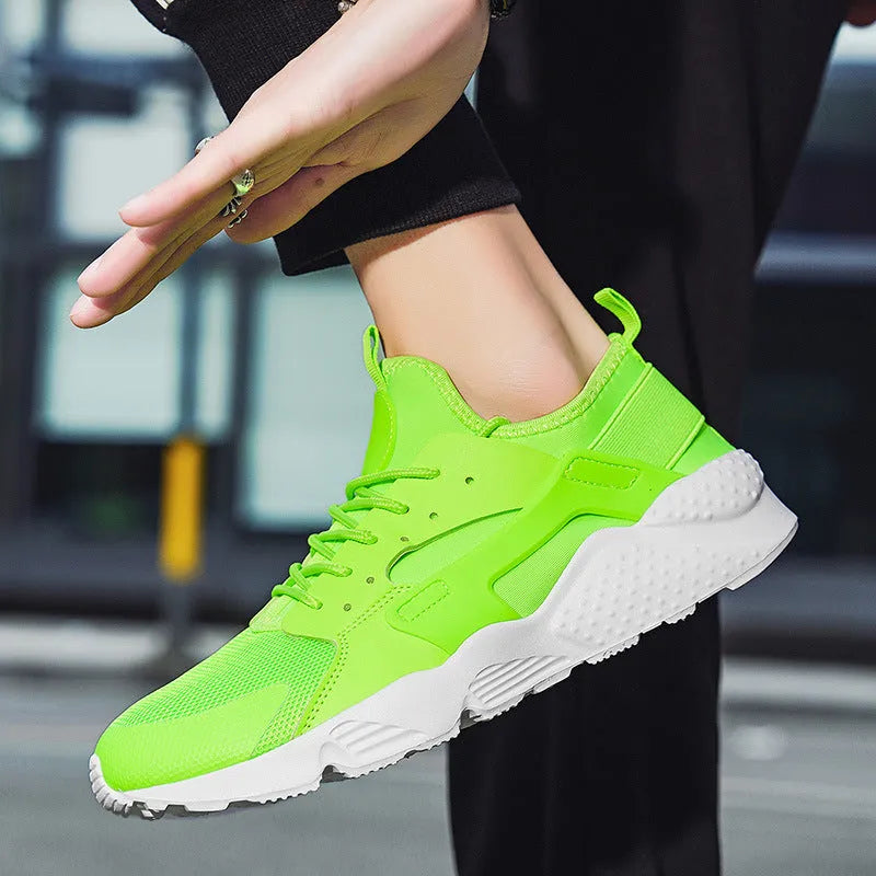 Men's low top casual shoes in green with mesh upper, flat heel, and lace-up front closure