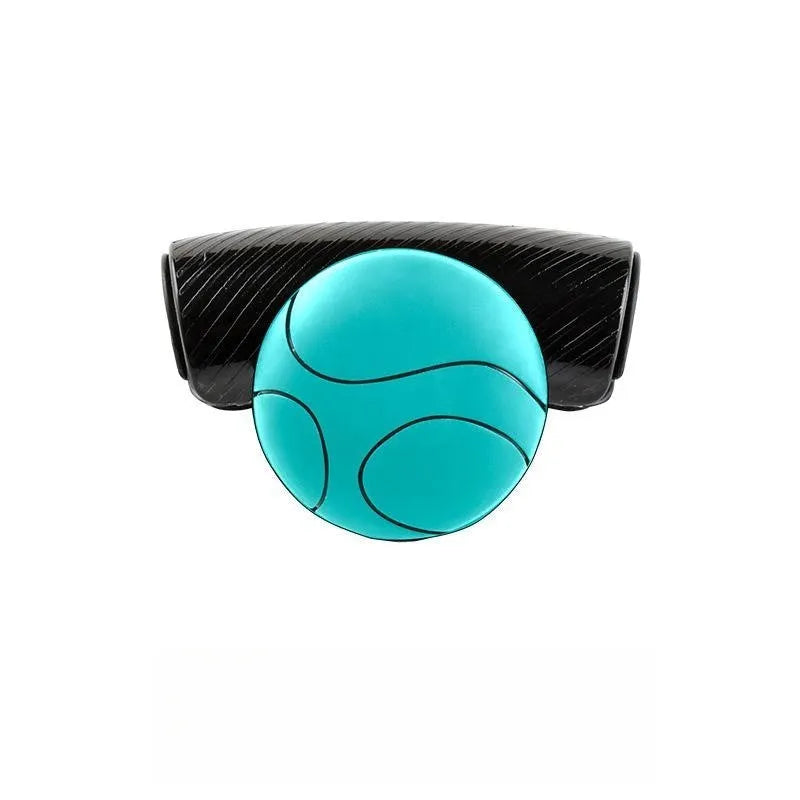 Black silicone steering wheel assist ball with metal bearing booster on a car steering wheel.