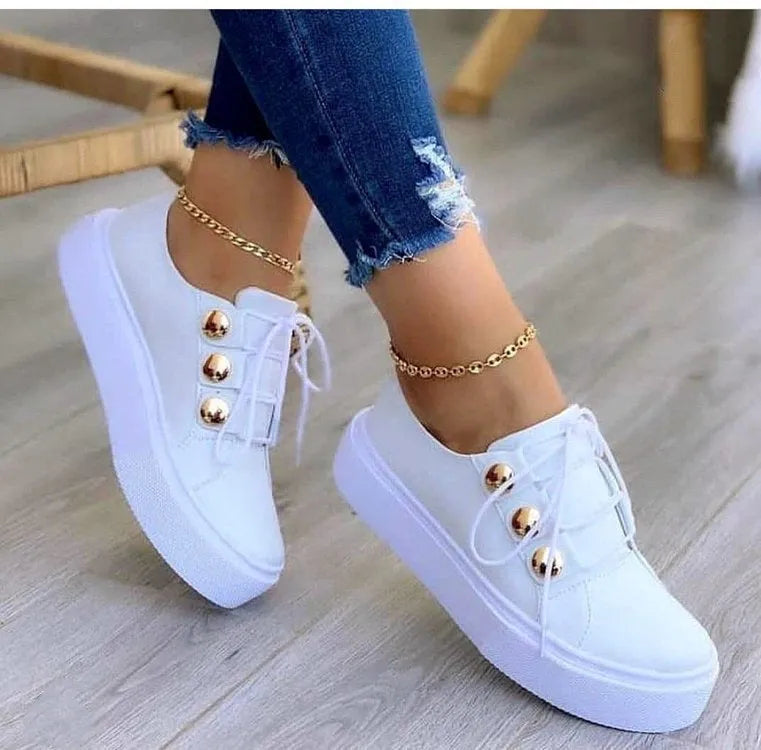 Women's lace-up flats sneakers with rivet detail, artificial PU upper, round toe, and polyurethane sole in white, black, gold, or rose gold.