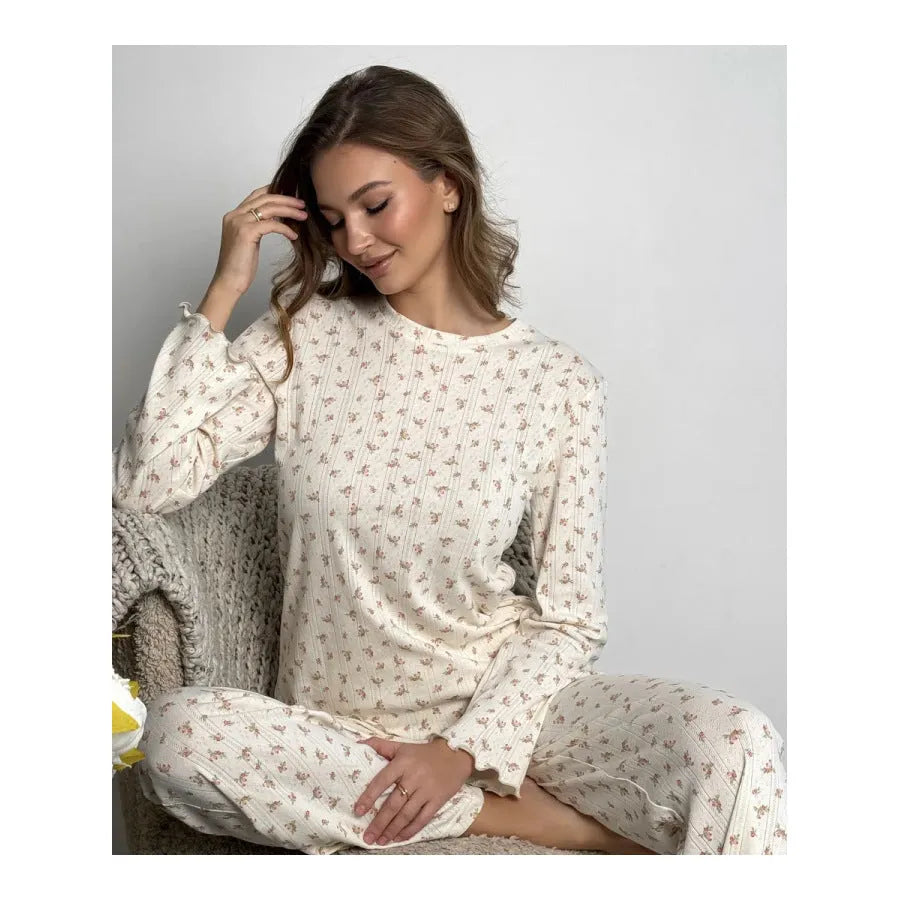 White floral print women's loungewear suit with bell sleeve top and wide-leg trousers.