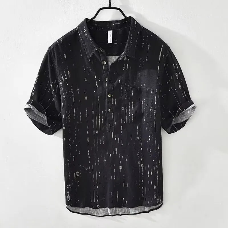 A man's loose-fitting black lapel polo shirt with short sleeves on a hanger.