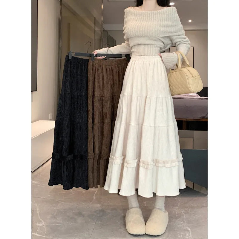 Women's milky white corduroy A-line midi skirt with an elastic waistband on a hanger.