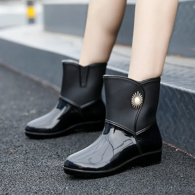 Women's purple rain boot with middle tube height and textured non-slip sole.