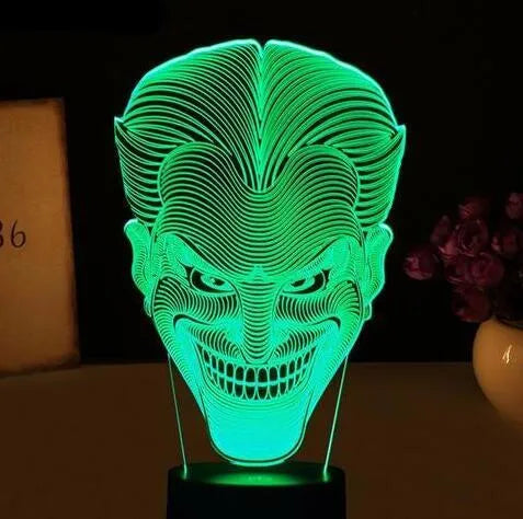 3D acrylic LED lamp on a base showing multi-colour gradient lighting, with a USB cable and remote control.