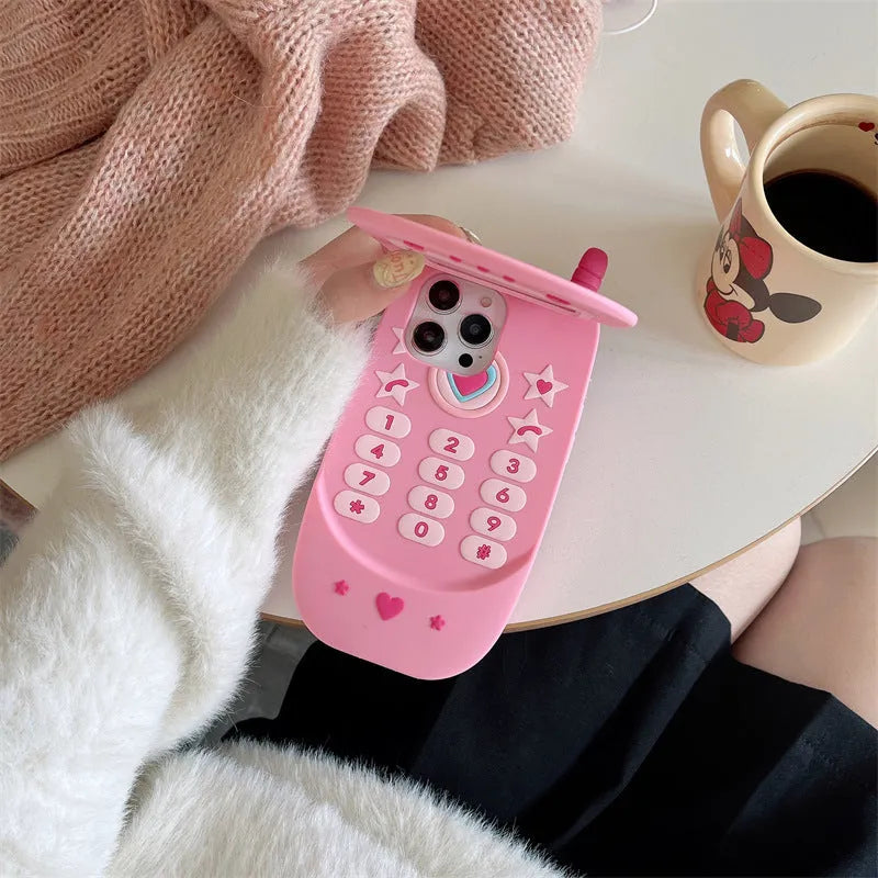 Pink silicone flip phone shape case with a mirror, designed for iPhone models.