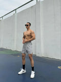 Men's ice silk quick-drying double-layer shorts in light grey, showing casual fit and elastic waistband.
