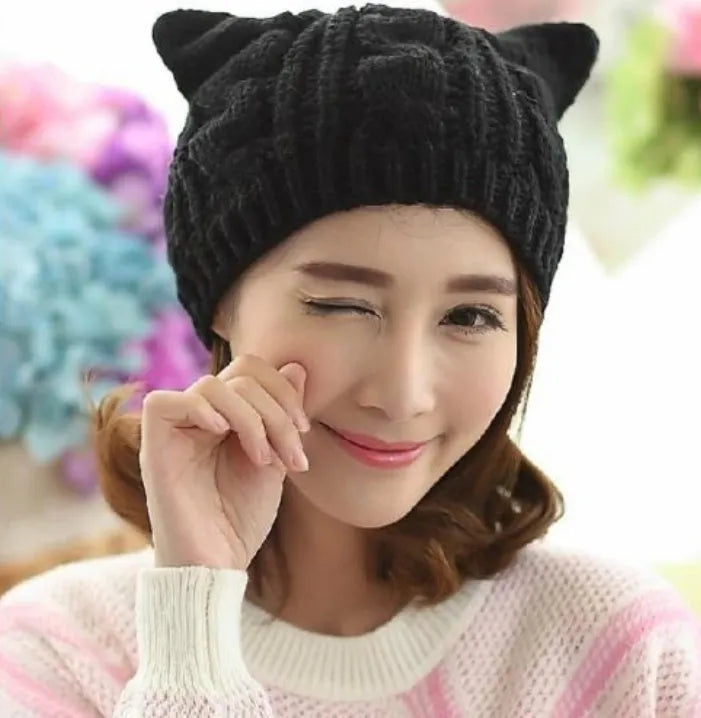 Hand-made chunky wool beanie with 3D knitted cat ears on a white background.