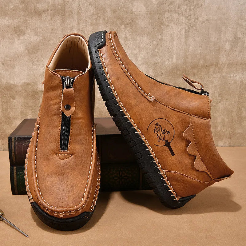 Men's black slip-on loafers with round toe and low heel design showing sewing detail on PU upper