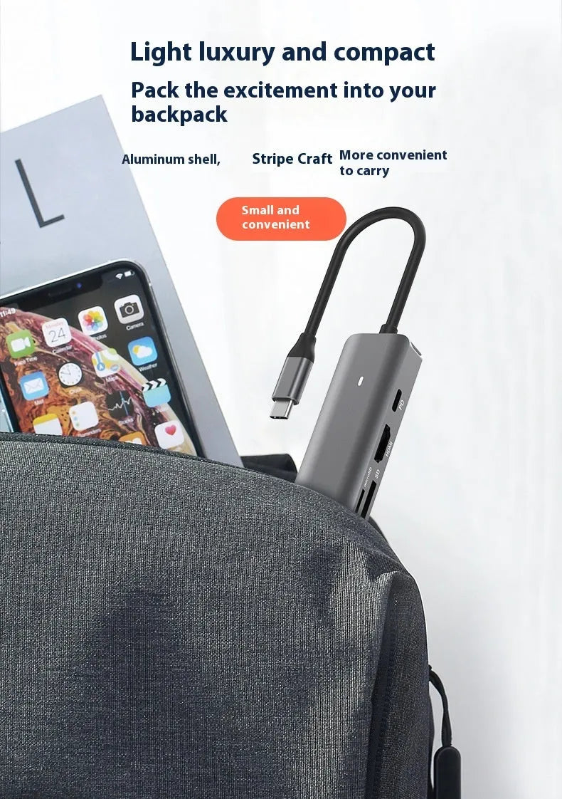 Black USB-C 7-in-1 computer hub with HDMI, USB ports and memory card slots