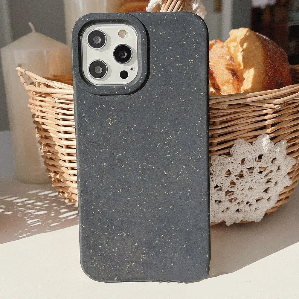Fully degradable wheat straw bioplastic rear cover case for Apple iPhone on a table, shown in one of seven available colours.