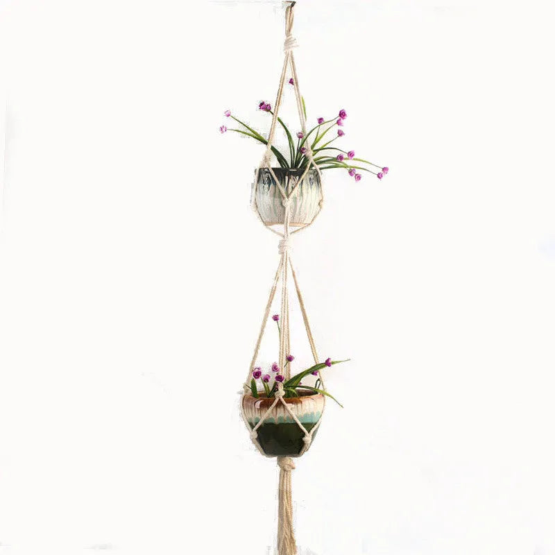 Woven cotton rope plant holder in a desktop style with greenery inside.