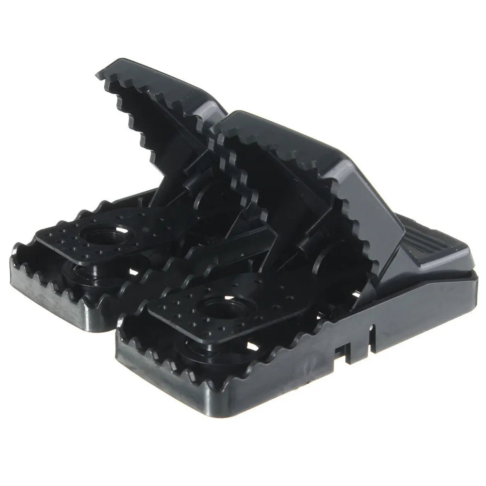 Six black plastic snap-action mousetraps showing their size and smooth surface.