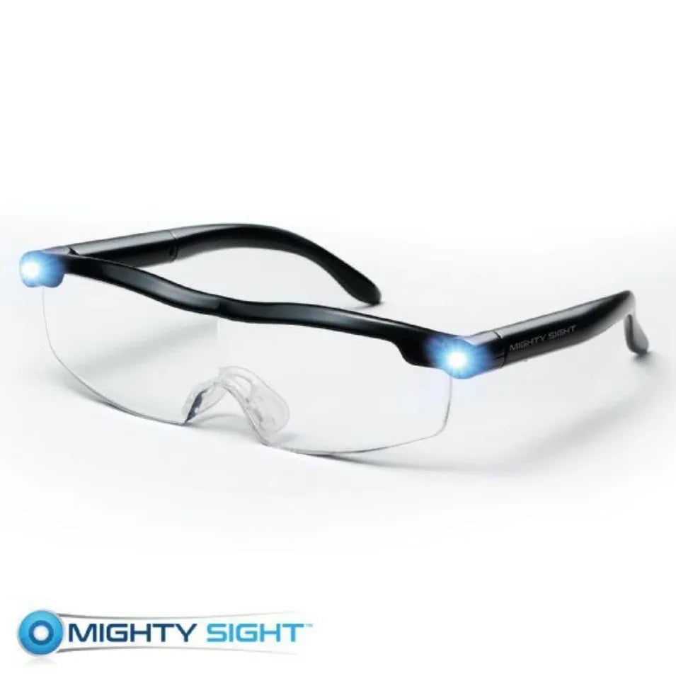 Transparent black USB LED light reading glasses on a desk