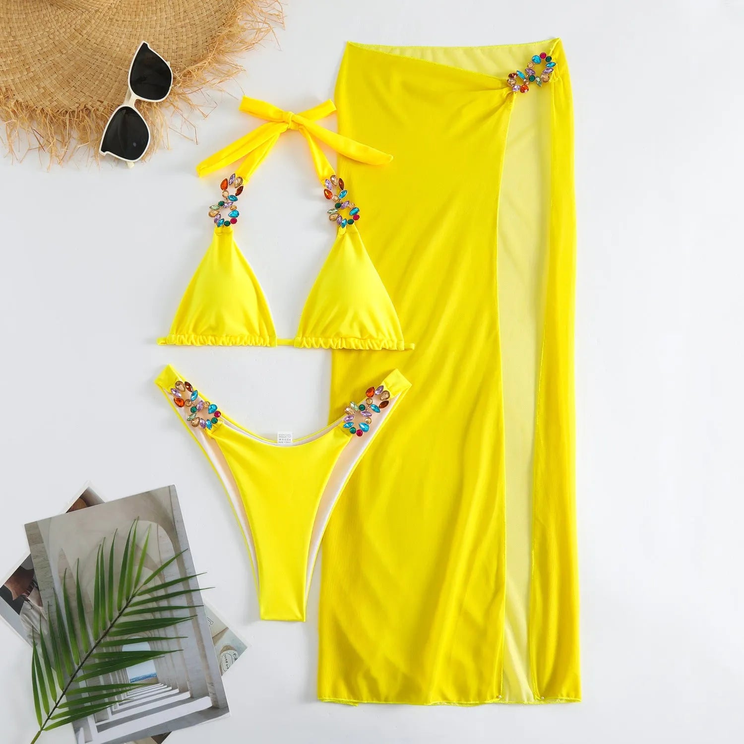 Rose Red three-piece women's swimsuit set with bikini top, briefs, and long mesh skirt laid flat.