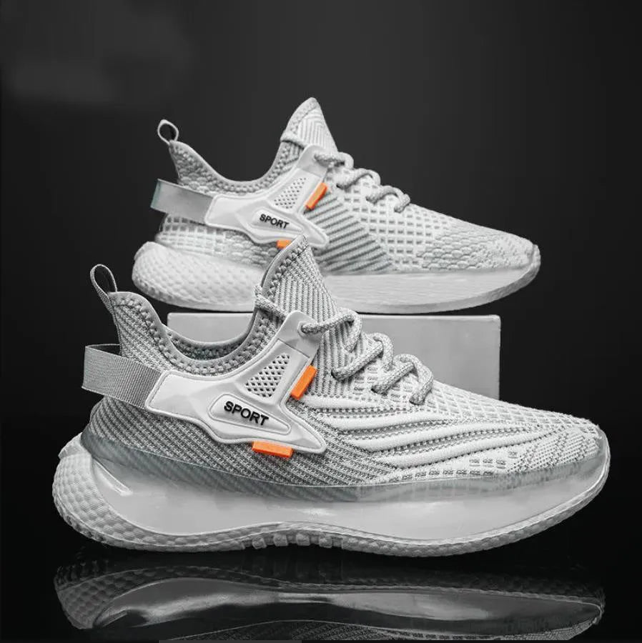 Men's low-top white mesh sneakers with a rubber sole and round toe on a plain background.