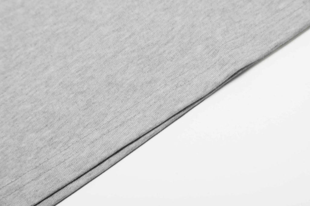 Man wearing a loose fit grey long sleeve cotton t-shirt for casual wear.