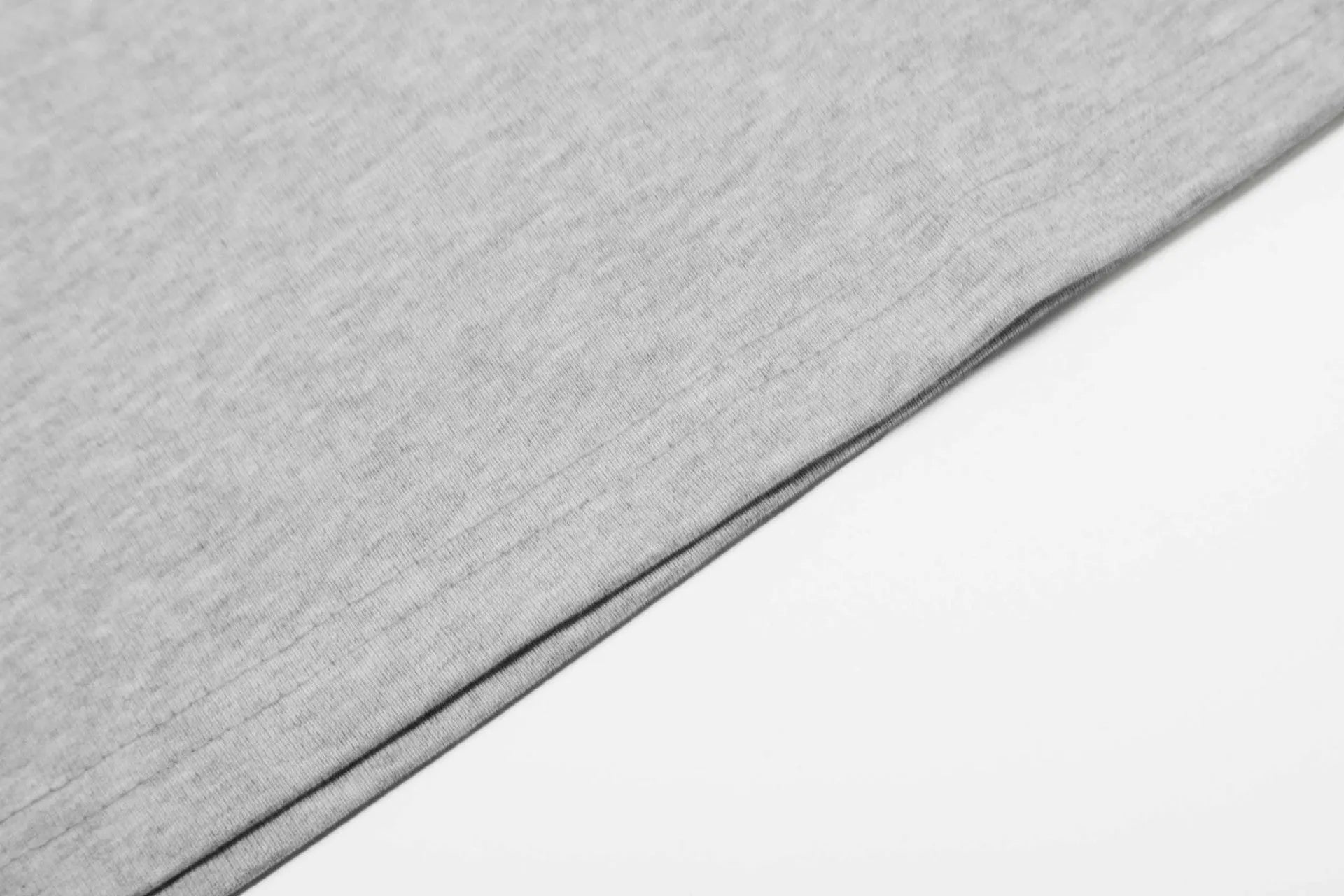 Man wearing a loose fit grey long sleeve cotton t-shirt for casual wear.