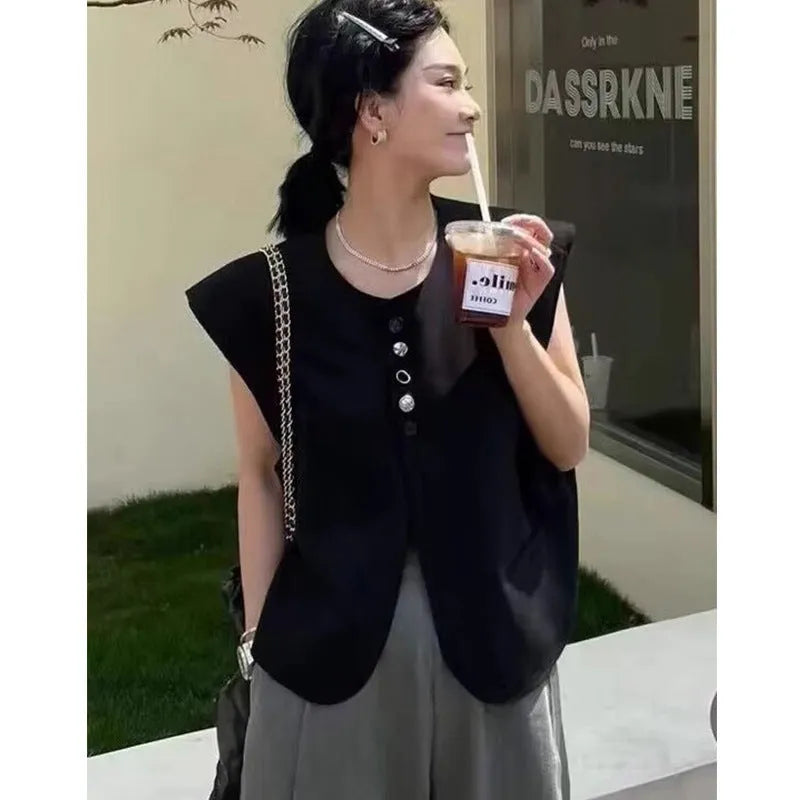 Women's loose fit polyester vest in milky white and black colours with pocket details.