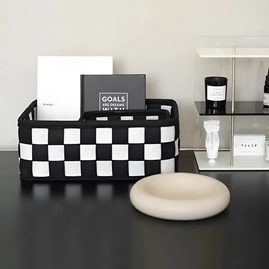 Checkerboard patterned grey and white felt folding storage box with woven design.