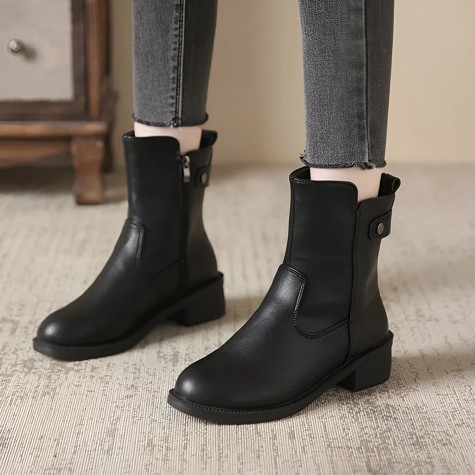 Black women's low heel side zip ankle boots with round toe on a white background.