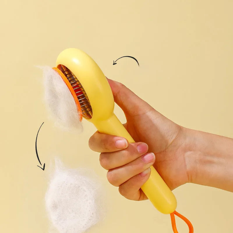 Small yellow duck-shaped pet grooming comb with open section and floating needles