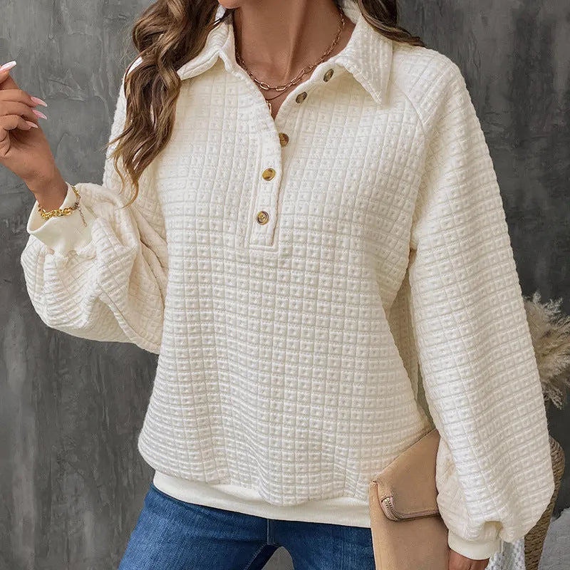 Women's milky white sweater with a polo collar and long sleeves laid flat.