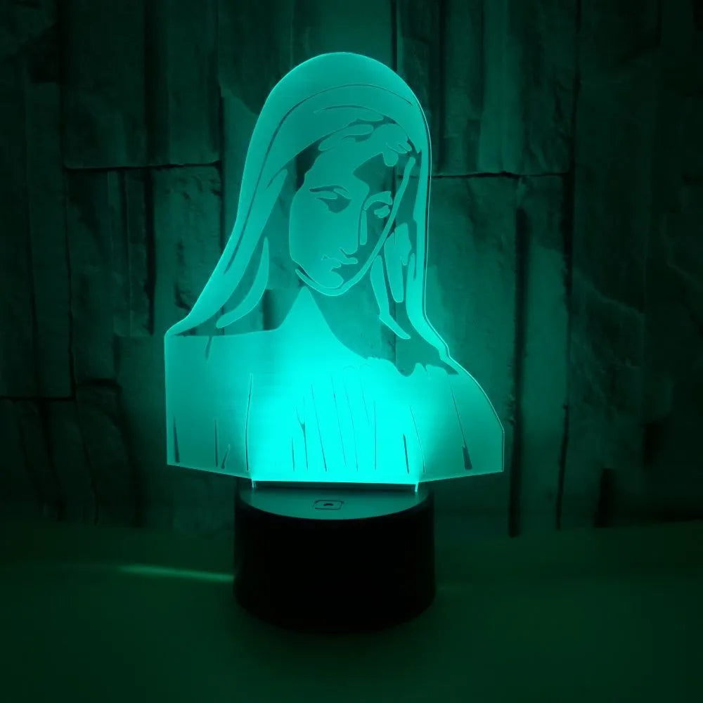 3D LED night light with colourful dual-ring pattern, remote control, and USB cable on a desk.