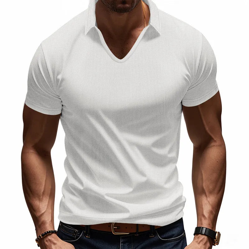 Man wearing a loose-fit apricot coloured V-neck short sleeve cotton blend T-shirt.