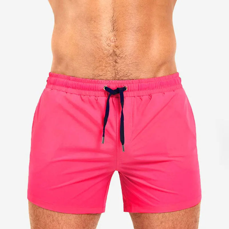 Men's solid colour swimming shorts with mesh lining for sports and fitness activities