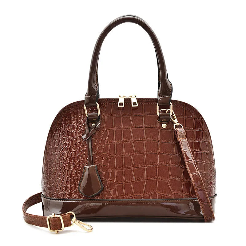 Large black structured shell-shaped crossbody shoulder bag with shoulder strap