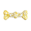 Green, white, and yellow camouflage pattern natural rubber bone chew toy for large breed dogs on a plain background.