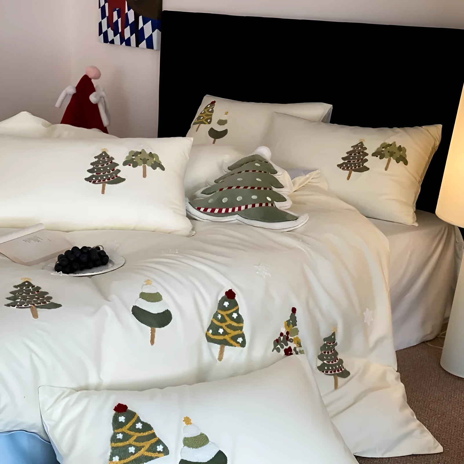 Cream blue Christmas tree embroidered pure cotton duvet cover, flat sheet, and pillowcases on a bed.