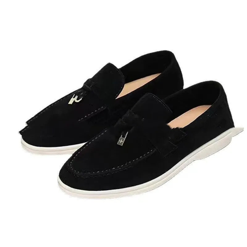 Gommino style high-top slip-on loafers in black with rubber sole and round steel toe.